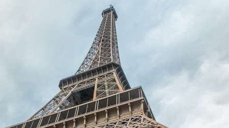 Eiffel Tower Hips timelapse - Shot from the base of the Eiffel Tower, cloudy sky on the background...