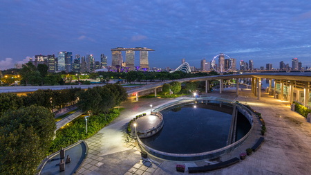 Marina Bay Sands, Gardens by the bay with cloud forest, flower dome and supertrees night to day transition timelapse before sunrise. Top view from marina barrageのeditorial素材