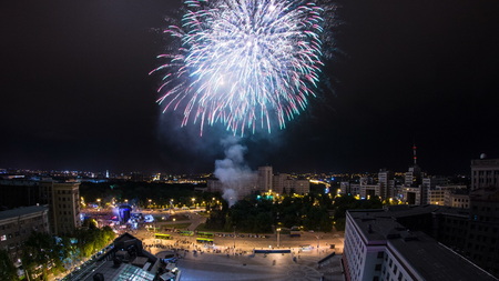 Kharkiv city from above at night timelapse. Aerial view of the city center and freedom square with...