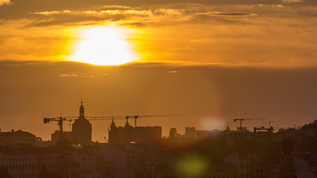 Lisbon at sunset aerial panorama view of city centre with red roofs at Autumn evening , Portugal. Top view from Miradouro da Nossa Senhora do Monte viewpointの写真素材