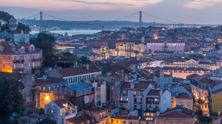 Lisbon after sunset aerial panorama view of city centre with red roofs at Autumn day to night transition , Portugal. Top view from Sophia de Mello Breyner Andresen viewpointの写真素材
