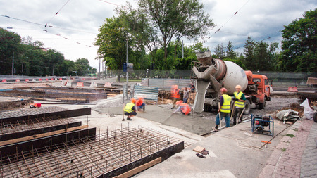 Concrete works for road construction with many workers and mixer machine timelapse. Reconstruction...