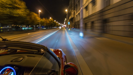Car moves at fast speed at the night streets timelapse hyperlapse drivelapse. Blured road with lights reflected from car on high speed. Prague, Czechの写真素材