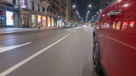 Car moves at fast speed at the night avenue timelapse hyperlapse drivelapse. Blured road with lights reflected from car on high speed. Milan, Italyの写真素材