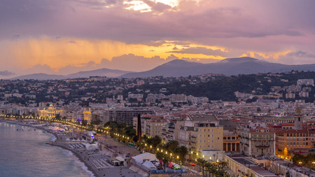 Panorama over Nice city and Mediterranean Sea aerial day to night transition timelapse. Bay of Angels with dramatic sky from Castle viewpoint, Cote d'Azur, French Riviera, Franceの写真素材