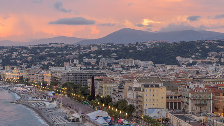 Panorama over Nice city and Mediterranean Sea aerial day to night transition timelapse. Bay of Angels with dramatic sky from Castle viewpoint, Cote d'Azur, French Riviera, Franceの写真素材