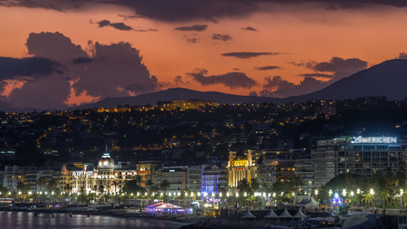 Waterfront of Nice city and Mediterranean Sea day to night transition timelapse. Bay of Angels with dramatic sky from Promenade with reflection in water, Cote d'Azur, French Riviera, Franceの写真素材