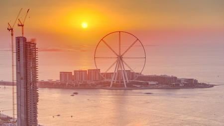 Bluewaters island at sunset aerial timelapse with ferris wheel, new walking area with shopping mall and restaurants, newly opened leisure and travel spot in Dubaiの写真素材
