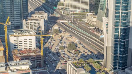 Aerial view of traffic on Business Bay with parking timelapse. Big modern city with skyscrapers and...