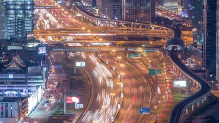 Night traffic on a busy intersection on Sheikh Zayed road highway aerial timelapse. View from...