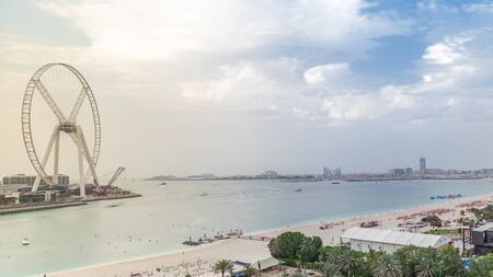 Aerial view of beach skyline and tourists walking in JBR timelapse in Dubai, UAE. Skyscrapers on a background. Waterfront with many activities and attractions, shops and restaurantsの写真素材