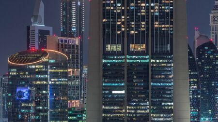 Aerial view to downtown and financial district in Dubai night timelapse, United Arab Emirates with illuminated skyscrapers and highways.の写真素材
