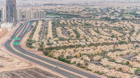 Aerial view of apartment houses and villas in Dubai city timelapse near jumeirah lake towers district, United Arab Emirates. Top fiew from skyscraperの写真素材