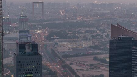 Aerial view to financial and zabeel district night to day transition timelapse with traffic and...
