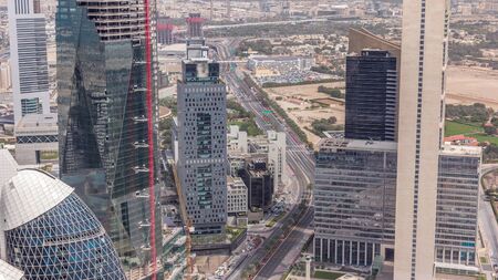 Skyline view of the buildings of Sheikh Zayed Road and DIFC aerial timelapse in Dubai, UAE. Modern...