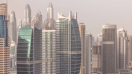 Residential apartments and offices in Jumeirah lake towers district timelapse in Dubai. Aerial panoramic view from above with modern skyscrapersの写真素材