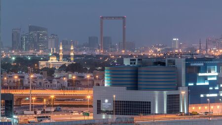 Zabeel district from night to morning transition. Aerial view of skyscrapers and mosque Business Bay, Dubai, United Arab Emirates timelapseの写真素材