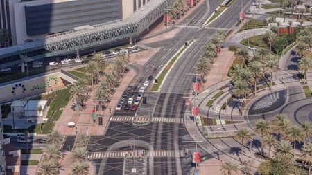 Aerial view of intersection with many transports in traffic and modern walking alley with fountain...