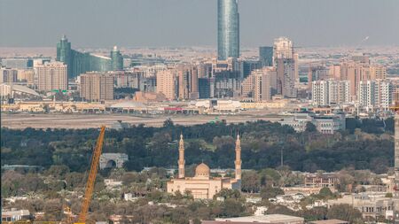 Aerial view to Dubai Creek with festival city timelapse. Mosque and skyscrapers with warm construction site from Downtown. Dubai - UAEの写真素材