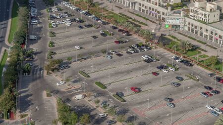 Aerial view full cars at large outdoor parking lots timelapse in Dubai, UAE. Office and recidential...