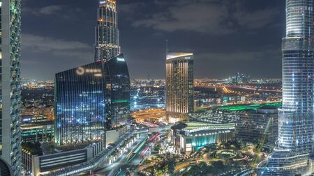Dubai downtown skyscrapers amazing aerial view at night timelapse with fountains and traffic on streets, Dubai, United Arab Emirates. Illuminated modern towers and construction siteの写真素材