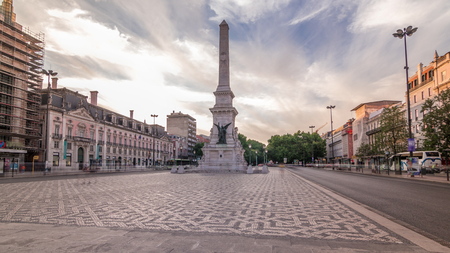 Monument to the Restorers timelapse hyperlapse at Restauradores Square Lisbon, Portugal. Historic buildings around and colorful sky before sunsetのeditorial素材