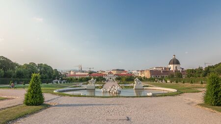 Belvedere palace with beautiful floral garden timelapse hyperlapse, Vienna Austria. Blue sky with clouds on sunny day. Green lawn and historic buildingsのeditorial素材