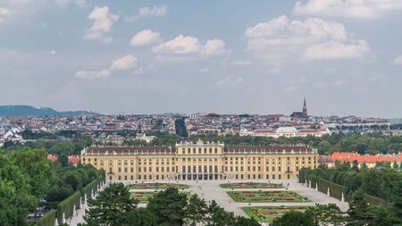 Beautiful view of famous Schonbrunn Palace timelapse hyperlapse with Great Parterre garden and lake in Vienna, Austria. City panorama on a backgroundのeditorial素材