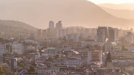 Panoramic aerial cityscape of the historical downtown of Sarajevo timelapse, Bosnia and Herzegovina, with famous buildings and hazy weather before sunset from viewpointの写真素材