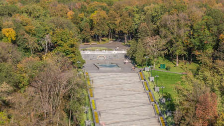 Aerial panoramic view to a staircase with fountains in the Shevchenko Garden timelapse. Park with yellow, red and green trees at autumn evening. Kharkov, Ukraineの写真素材