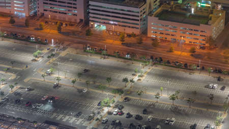 Big parking lot near mall crowded by many cars timelapse aerial view