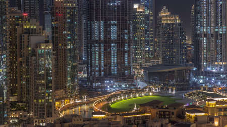 Futuristic aerial night cityscape timelapse with illuminated architecture of Dubai downtown, United Arab Emirates.の写真素材