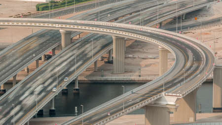 Top view city traffic on a crossroad with bridge over canal in Business bay timelapse. Aerial top...