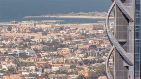 Aerial view of many apartment houses and villas in Dubai city timelapse from skyscraper in downtownの写真素材