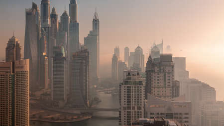 View of various skyscrapers in tallest recidential block in Dubai Marina aerial timelapseの写真素材