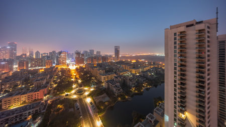 Skyscrapers in Barsha Heights district and low rise buildings in Greens district aerial night to day timelapse.の写真素材
