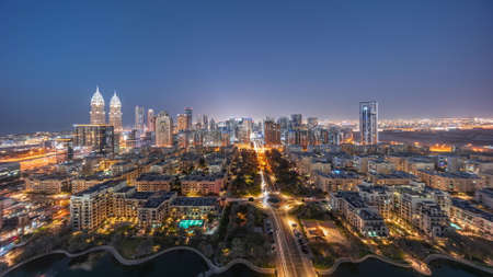 Skyscrapers in Barsha Heights district and low rise buildings in Greens district aerial day to night timelapse.の写真素材