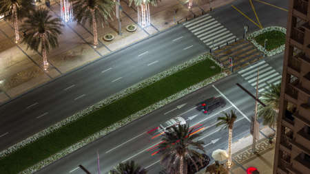 Bussy traffic on the road in Dubai downtown aerial night timelapse, UAE