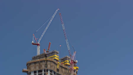 Cranes working on big constraction site works of new skyscraper timelapse