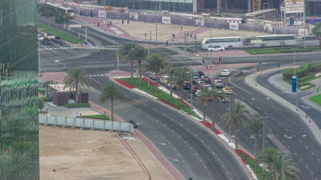 Aerial top view of city traffic on a crossroad in Dubai Business bay timelapse.