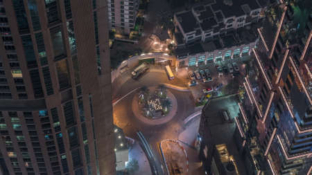 Aerial view of a road intersection between skyscrapers in a big city timelapse.