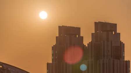 Sunset over Dubai international financial center skyscrapers aerial timelapse.の写真素材