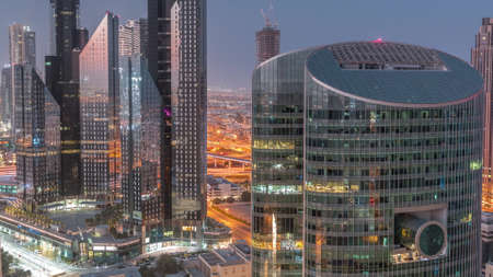 Dubai international financial center skyscrapers aerial night to day timelapse.