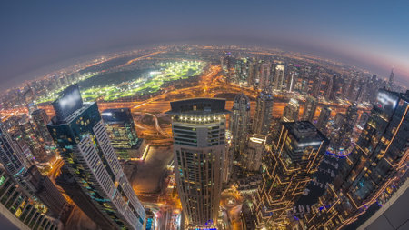 Panorama of Dubai Marina with JLT skyscrapers and golf course day to night timelapse, Dubai, United Arab Emirates.の写真素材