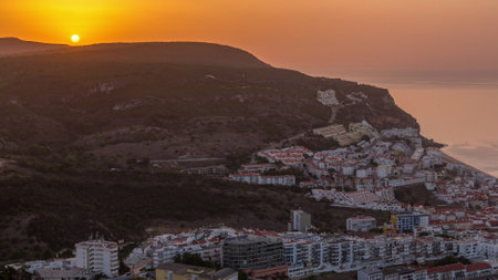 Aerial sunrise view of the coastline of the village of Sesimbra timelapse. Portugalの写真素材