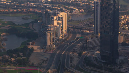 Big crossroad junction between JLT district and Dubai Marina intersected by Sheikh Zayed Road aerial durind all day with moving shadows. Car traffic near skyscrapers. hazy weatherの写真素材