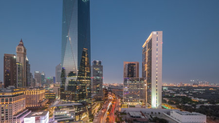 Dubai International Financial district day to night transition. Panoramic aerial view of business...