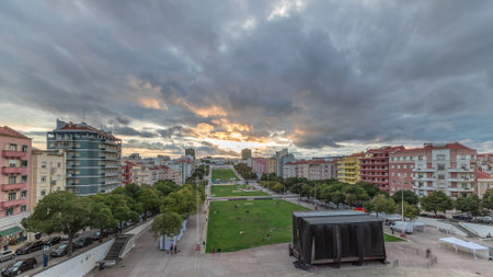 Panorama showing aerial view of Jardim da Alameda in Lisbon with the Luminous Fountain timelapse during sunset.の写真素材