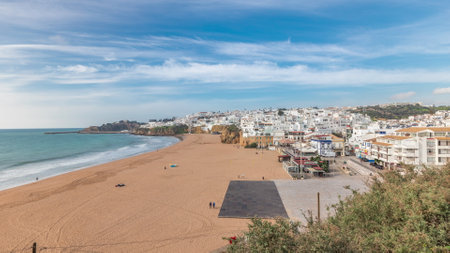 Wide sandy beach and Atlantic ocean in city of Albufeira timelapse. Algarve, Portugalの写真素材