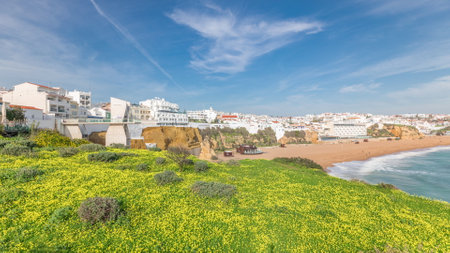 Wide sandy beach and Atlantic ocean in city of Albufeira timelapse. Algarve, Portugalの写真素材